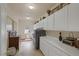 Well-equipped laundry room featuring ample cabinet space and modern washer/dryer units at 8356 Shady Lady Ct, Las Vegas, NV 89131