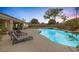 Resort-style pool and patio area with lounge chairs for relaxing, ideal for enjoying warm weather and outdoor living at 8356 Shady Lady Ct, Las Vegas, NV 89131
