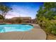 Backyard pool surrounded by lush landscaping and mature trees at 8356 Shady Lady Ct, Las Vegas, NV 89131