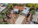 Desert home with a red tile roof, expansive driveway, mature landscaping, and a two-car garage at 853 Morning Sun Ct, Las Vegas, NV 89110
