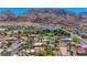 Mountain view featuring a unique building, manicured landscaping, and neighborhood pools at 853 Morning Sun Ct, Las Vegas, NV 89110