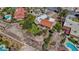 Expansive property with a terracotta-roofed home, mature trees, lush landscaping, and circular water feature at 853 Morning Sun Ct, Las Vegas, NV 89110