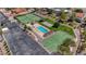 Aerial view of a community swimming pool, tennis court, and basketball court with desert landscaping at 853 Morning Sun Ct, Las Vegas, NV 89110