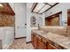 Bathroom featuring a walk-in bathtub, large mirror, and tiled countertops at 853 Morning Sun Ct, Las Vegas, NV 89110
