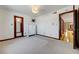Spacious bedroom featuring plush carpeting, modern lighting, and an adjoining bathroom at 853 Morning Sun Ct, Las Vegas, NV 89110