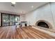Bright dining area featuring a fireplace, wood floors, and sliding glass doors leading to the backyard at 853 Morning Sun Ct, Las Vegas, NV 89110