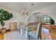 Open concept dining area with natural light and chandelier at 853 Morning Sun Ct, Las Vegas, NV 89110