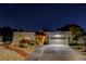 Charming single-story home at night featuring desert landscaping, stucco walls, and a two-car garage at 853 Morning Sun Ct, Las Vegas, NV 89110
