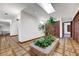 Bright foyer features beautiful flooring, skylight, an indoor garden in brick planter and archways at 853 Morning Sun Ct, Las Vegas, NV 89110