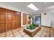 Bright foyer featuring unique tile flooring and a brick planter filled with lush greenery at 853 Morning Sun Ct, Las Vegas, NV 89110