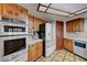 Modern kitchen features stainless steel appliances, wood cabinets, and tile flooring at 853 Morning Sun Ct, Las Vegas, NV 89110