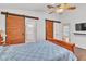 Bedroom with hardwood floors, ceiling fan and barn doors to bathroom and closet at 930 High Plains Dr, Henderson, NV 89002
