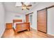 Bedroom featuring ceiling fan, skylight, barn doors to bathroom, and hardwood floors at 930 High Plains Dr, Henderson, NV 89002