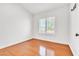 Minimalist bedroom with hardwood floors, a window, and plain white walls at 930 High Plains Dr, Henderson, NV 89002