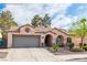 Charming single-story home with a two-car garage, tile roof, and a well-manicured front yard at 930 High Plains Dr, Henderson, NV 89002
