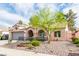 Charming front exterior with desert landscaping, wrought iron and gravel at 930 High Plains Dr, Henderson, NV 89002