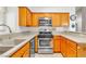 Efficient kitchen featuring oak cabinets, stainless steel appliances, and a double basin sink at 930 High Plains Dr, Henderson, NV 89002