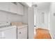 Laundry room featuring modern washer and dryer and shelving with bi-fold door at 930 High Plains Dr, Henderson, NV 89002