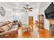 Living room with hardwood floors, ceiling fan and furniture with fireplace at 930 High Plains Dr, Henderson, NV 89002