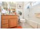 Bright bathroom features a tub-shower combo and vanity with granite countertop at 9921 Woodhouse Dr, Las Vegas, NV 89134