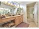 Bright bathroom featuring double sinks, vanity, and a separate glass-enclosed shower at 9921 Woodhouse Dr, Las Vegas, NV 89134