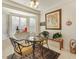 Bright breakfast nook with bay window, a round table and seating for two, filled with light at 9921 Woodhouse Dr, Las Vegas, NV 89134