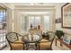Bright breakfast nook with bay window, a round table and seating for two with ornamental decor at 9921 Woodhouse Dr, Las Vegas, NV 89134