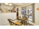 Bright breakfast nook with a sliding glass door to the back yard and seating for two at 9921 Woodhouse Dr, Las Vegas, NV 89134