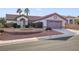 Charming single-story home showcasing well-maintained landscaping and a two-car garage at 9921 Woodhouse Dr, Las Vegas, NV 89134
