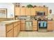 Functional kitchen featuring light wood cabinetry, stainless steel appliances, and granite countertops at 9921 Woodhouse Dr, Las Vegas, NV 89134