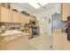 Bright kitchen with light wood cabinets, stainless steel appliances, and modern tile flooring at 9921 Woodhouse Dr, Las Vegas, NV 89134