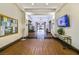 Bright and welcoming lobby with wood floors, a bulletin board, and a large TV, creating an inviting atmosphere at 9921 Woodhouse Dr, Las Vegas, NV 89134