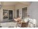 Charming covered patio with comfortable seating and ornate security gate at 9921 Woodhouse Dr, Las Vegas, NV 89134