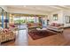 Cozy sitting area with comfortable sofas, armchairs, and a view of lush greenery, perfect for relaxation at 9921 Woodhouse Dr, Las Vegas, NV 89134