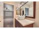 Bathroom vanity with granite counters and bright lighting. Bedroom viewable through door at 10159 Tumbling Tree St, Las Vegas, NV 89183