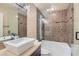 Bathroom with decorative tile features a glass shower, a tub, and a sink at 10159 Tumbling Tree St, Las Vegas, NV 89183