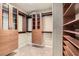 Spacious walk-in closet with custom wood shelving and drawers for optimal storage at 10159 Tumbling Tree St, Las Vegas, NV 89183