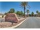 Well-manicured community entrance with palm trees and stone signage at 10159 Tumbling Tree St, Las Vegas, NV 89183