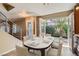 Dining room featuring a large dining table with a set table for six, a back door to an outdoor patio at 10159 Tumbling Tree St, Las Vegas, NV 89183