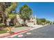 A side view of a two-story townhome with a landscaped yard and an attached two-car garage at 10159 Tumbling Tree St, Las Vegas, NV 89183
