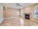 Spacious living room boasts neutral walls, tile flooring and a modern fireplace at 10159 Tumbling Tree St, Las Vegas, NV 89183