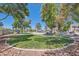 Beautiful park with lush green grass, mature trees, benches and walkways, near neighborhood at 10159 Tumbling Tree St, Las Vegas, NV 89183