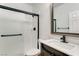 Bathroom with a new vanity, framed mirror, walk-in shower with black trim at 1124 Coral Rainbow Ave, Las Vegas, NV 89123