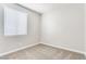 Clean and bright bedroom with neutral carpet and a large window at 1124 Coral Rainbow Ave, Las Vegas, NV 89123