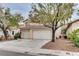 Charming two-story home with a two car garage and mature trees in front at 1124 Coral Rainbow Ave, Las Vegas, NV 89123