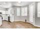 Eat-in kitchen area featuring wood-look flooring, ample natural light, and white cabinets at 1124 Coral Rainbow Ave, Las Vegas, NV 89123