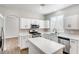 Bright modern kitchen features white cabinets, stone countertops, and stainless steel appliances at 1124 Coral Rainbow Ave, Las Vegas, NV 89123