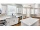 Modern kitchen with white cabinets, island with white countertop, and stainless steel appliances at 1124 Coral Rainbow Ave, Las Vegas, NV 89123