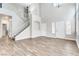 Bright living room with staircase, white walls, light fixtures, tile floors and natural light at 1124 Coral Rainbow Ave, Las Vegas, NV 89123