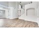 Open-concept living room with tall ceilings, white walls, light fixtures and wood-look floors at 1124 Coral Rainbow Ave, Las Vegas, NV 89123